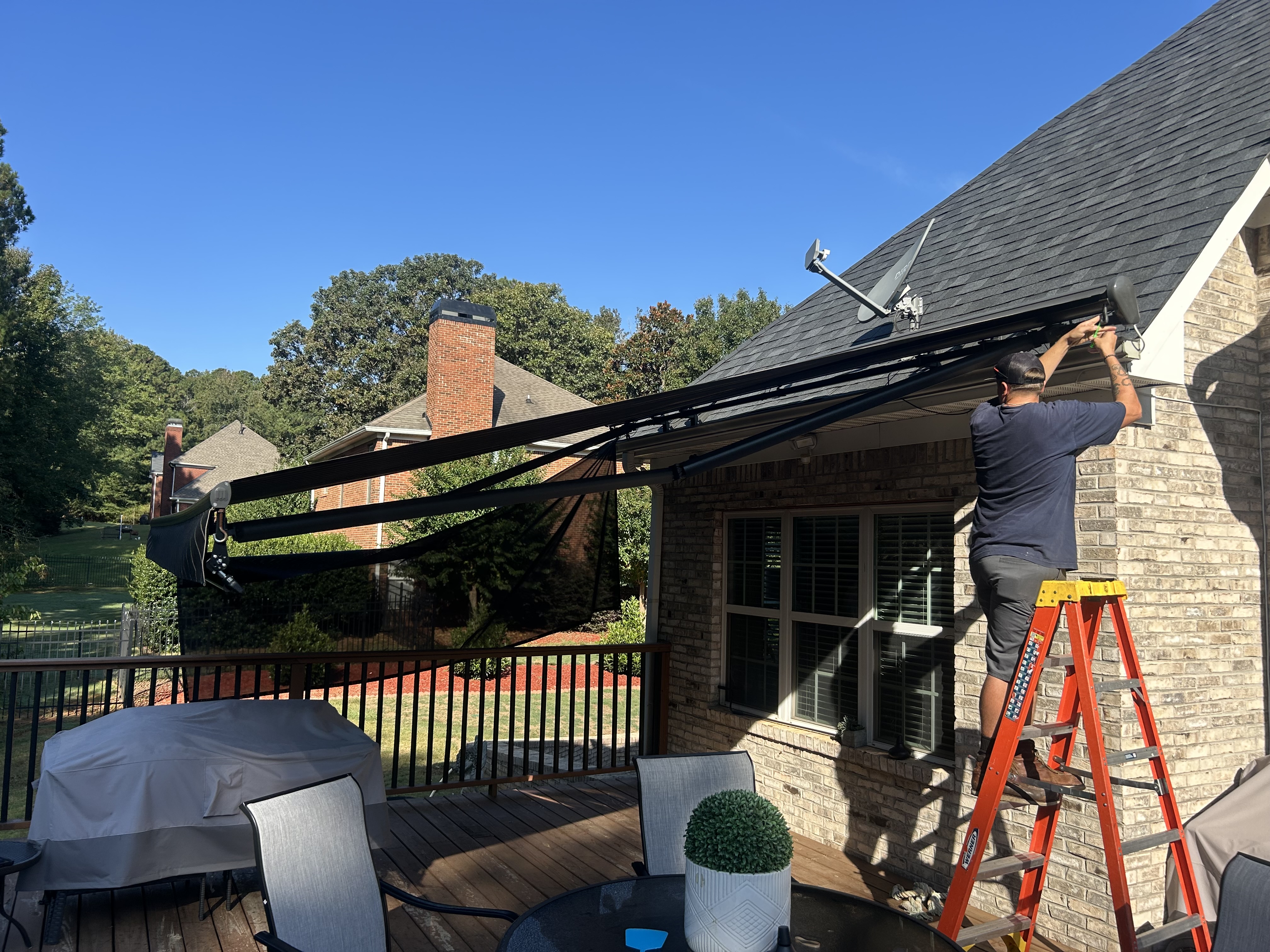 Technician adjusting a retractable awning